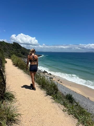 Georgie walking the coastal track above the beach